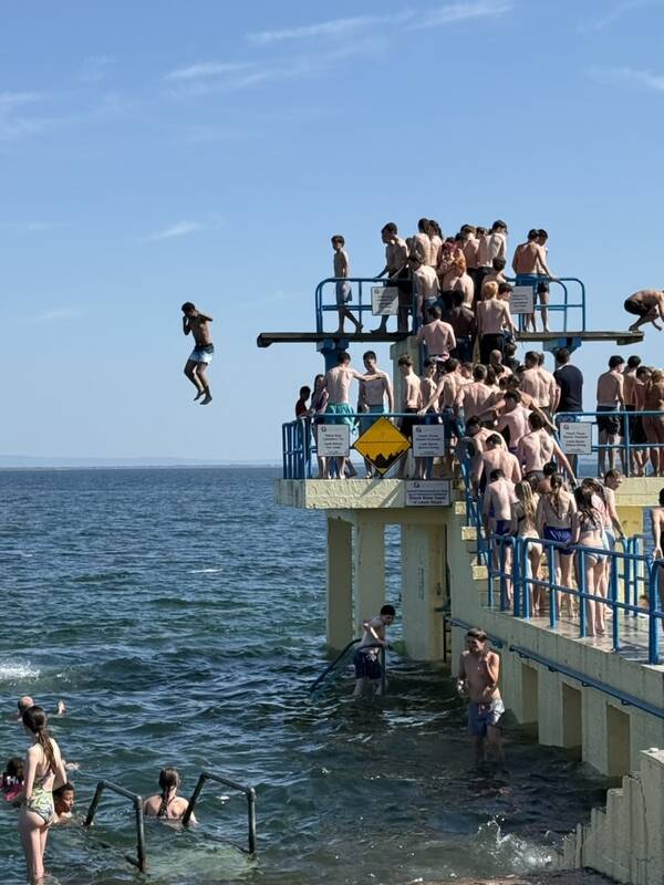 Kids jumping from the diving tower at Salthill, Galway